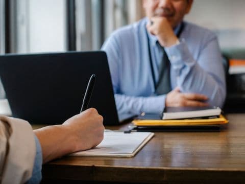 A solicitor advising a client across the desk