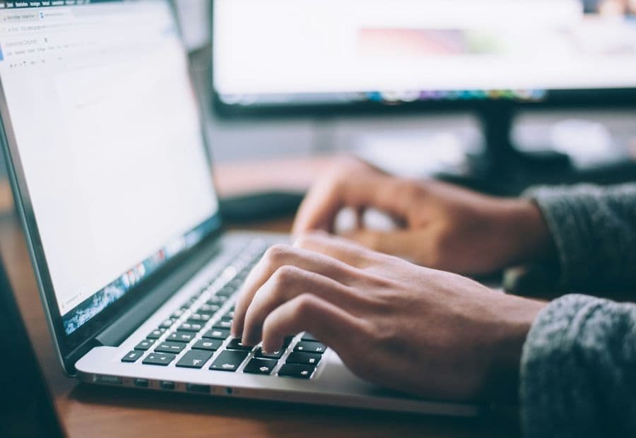 Hands at a keyboard, writing legal content for the public